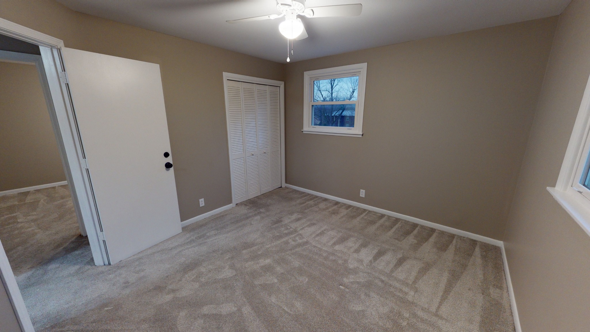 401 Burch Road Clarksville, TN 37042 - Photo 22 of 39 an empty room with a chandelier fan and windows