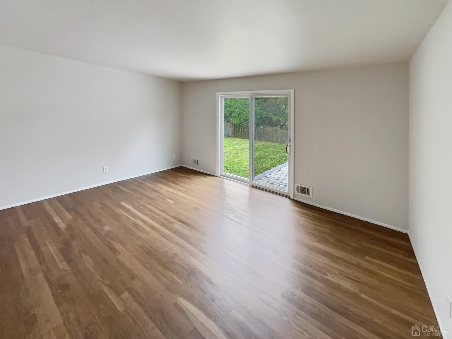 19 Clemson Road Old Bridge, NJ 08859 - Photo 14 of 23 a view of an empty room with wooden floor and a window