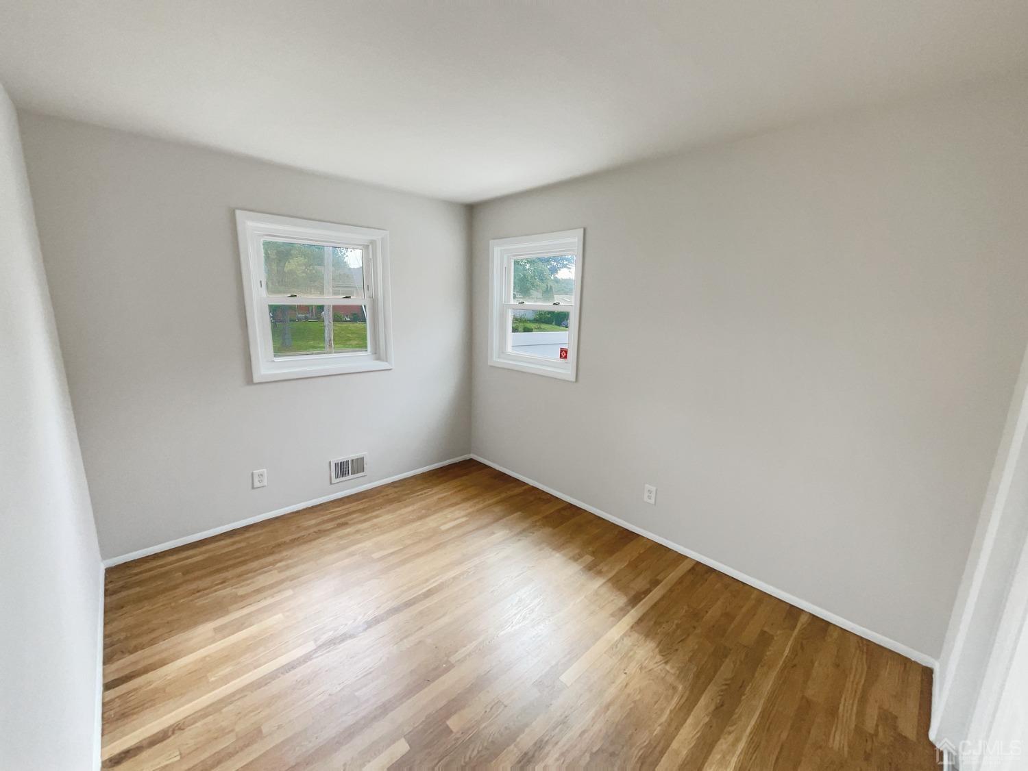 19 Clemson Road Old Bridge, NJ 08859 - Photo 16 of 23 a view of an empty room with wooden floor and a window