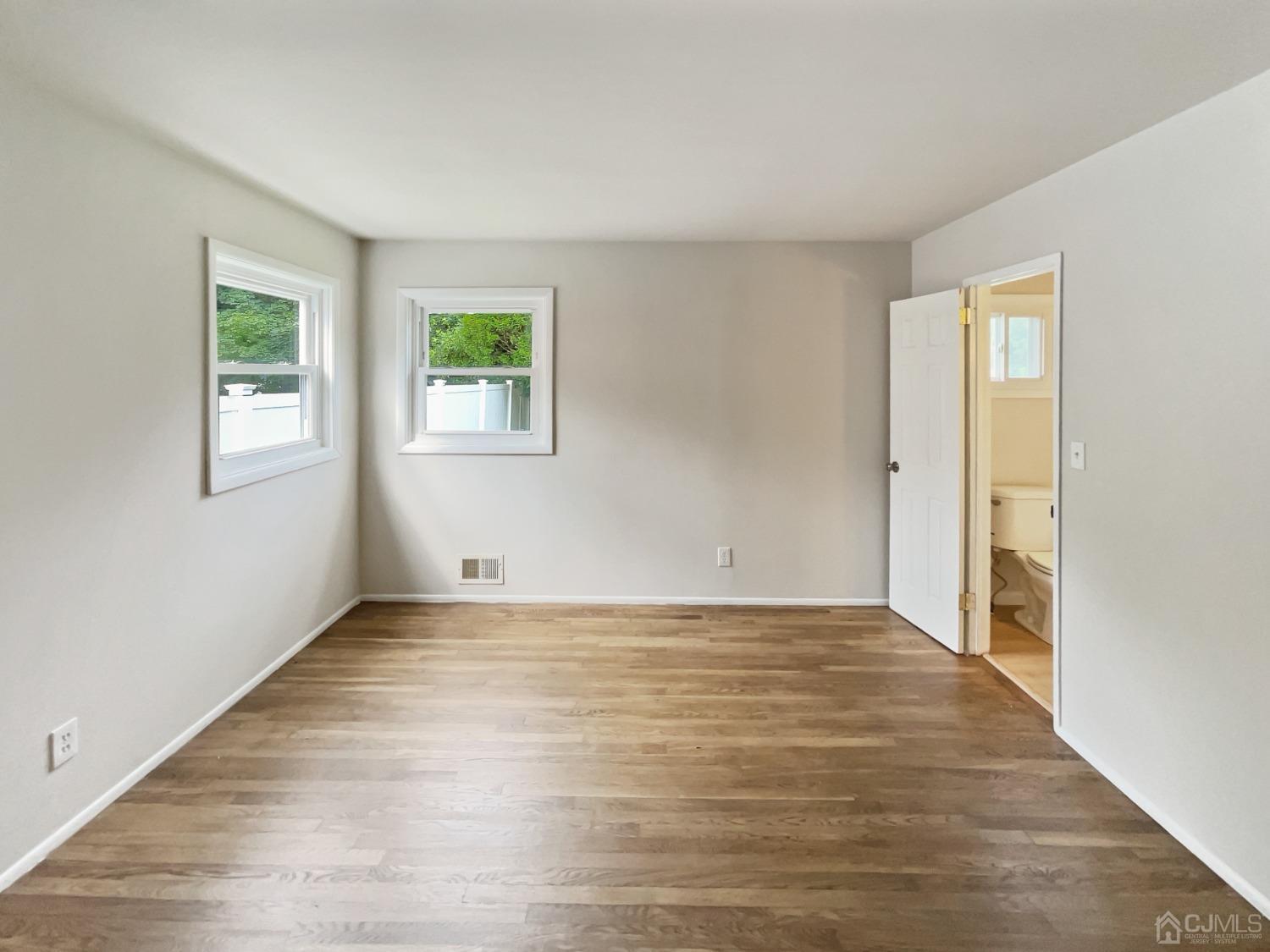 19 Clemson Road Old Bridge, NJ 08859 - Photo 17 of 23 a view of an empty room with wooden floor and a window