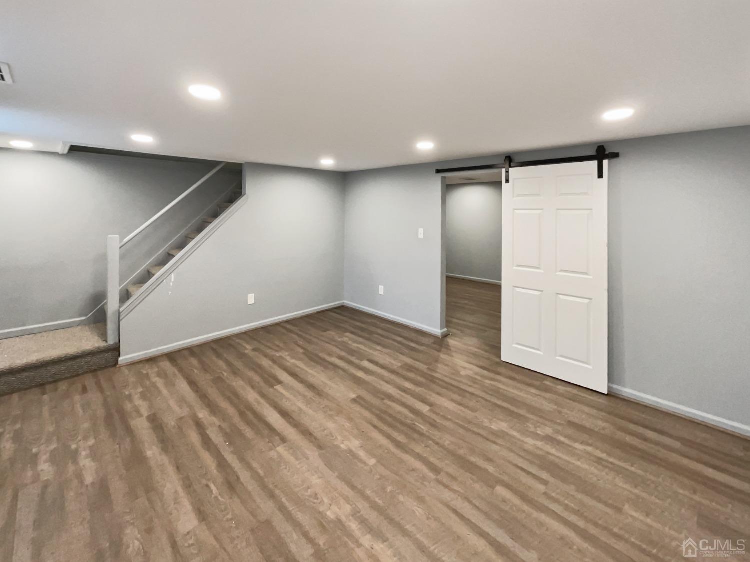 19 Clemson Road Old Bridge, NJ 08859 - Photo 20 of 23 an empty room with wooden floor and windows