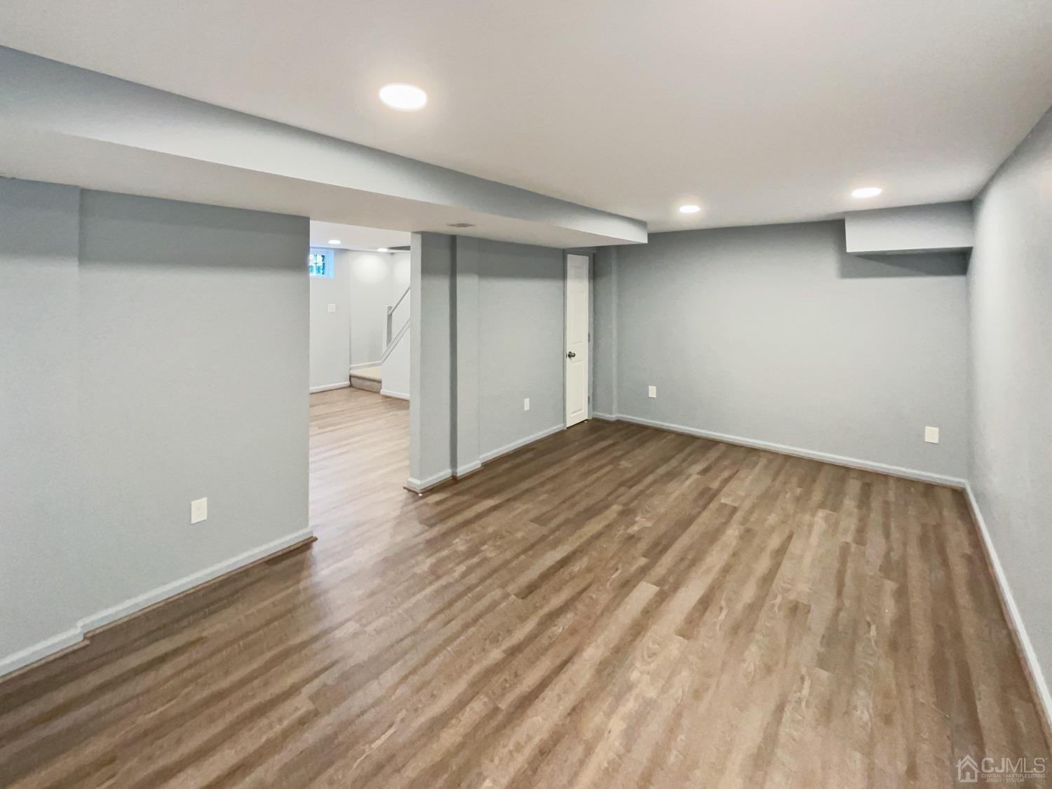 19 Clemson Road Old Bridge, NJ 08859 - Photo 21 of 23 an empty room with wooden floor and windows