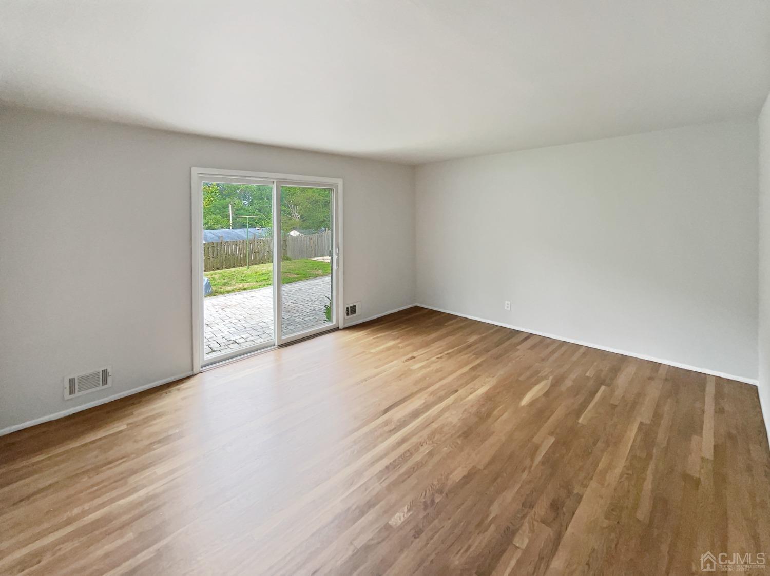 19 Clemson Road Old Bridge, NJ 08859 - Photo 3 of 23 a view of an empty room with wooden floor and a window