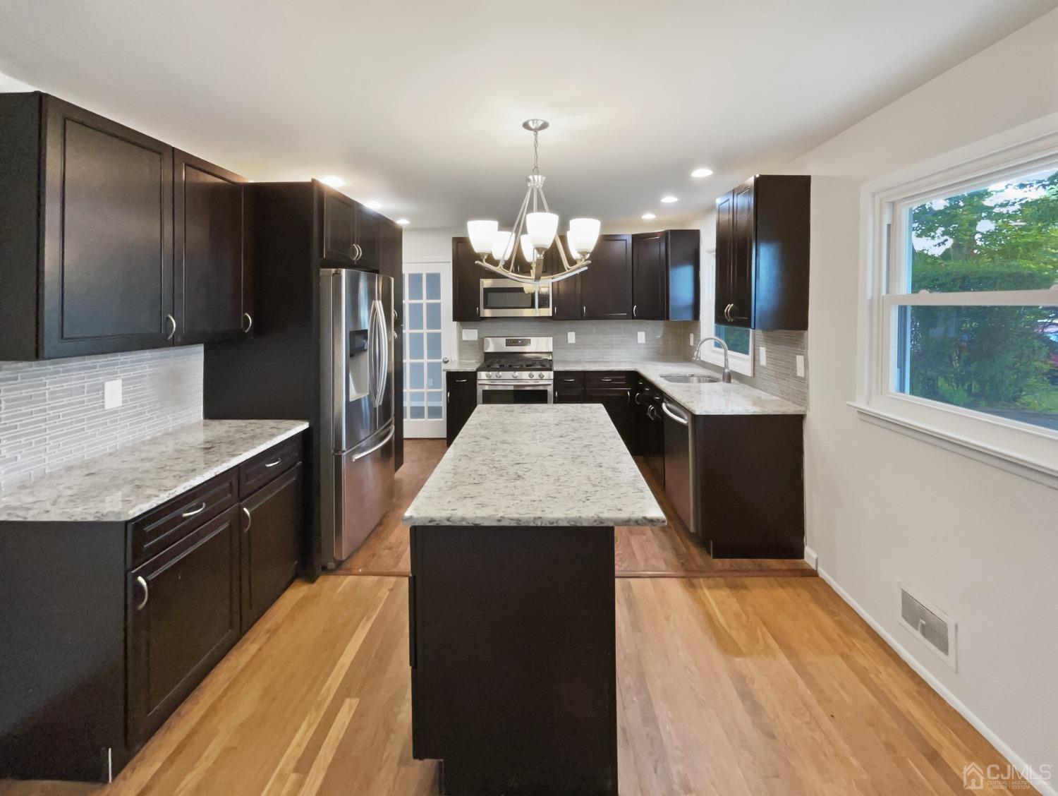 19 Clemson Road Old Bridge, NJ 08859 - Photo 6 of 23 a kitchen with granite countertop stainless steel appliances and wooden cabinets