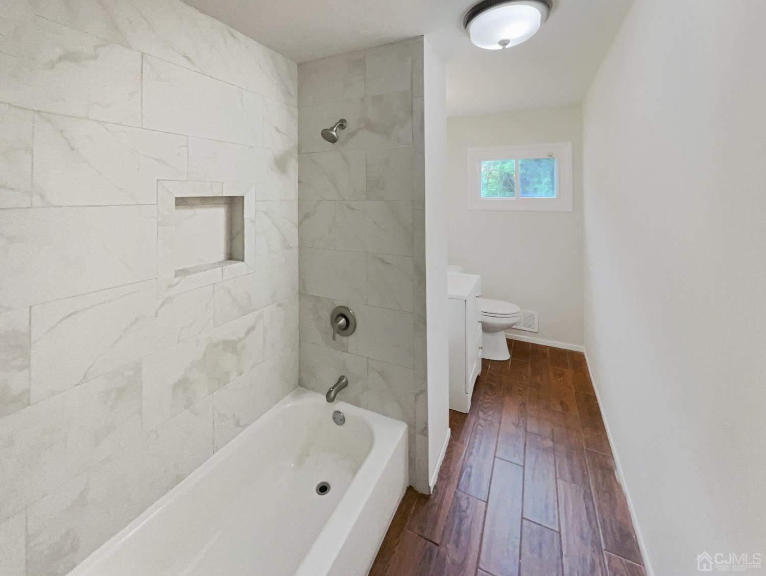 19 Clemson Road Old Bridge, NJ 08859 - Photo 7 of 23 a bathroom with a bathtub and a toilet