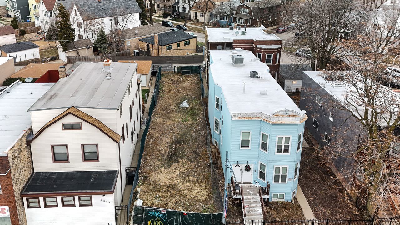 3675 North Elston Avenue Chicago, IL 60618 - Photo 1 of 19 a view of a house with wooden fence