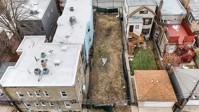 an aerial view of a residential apartment building with a yard