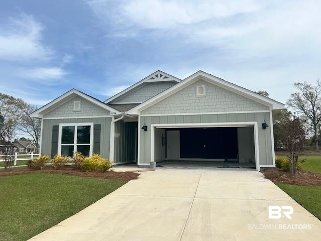 14984 Dayton Circle Foley, AL 36535 - Photo 1 of 37 View of front facade featuring board and batten siding, a garage, driveway, and a front lawn