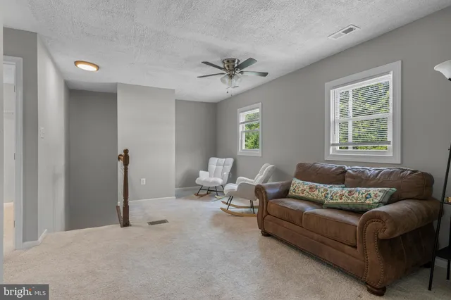 a bathroom view of a toilet and a shower
