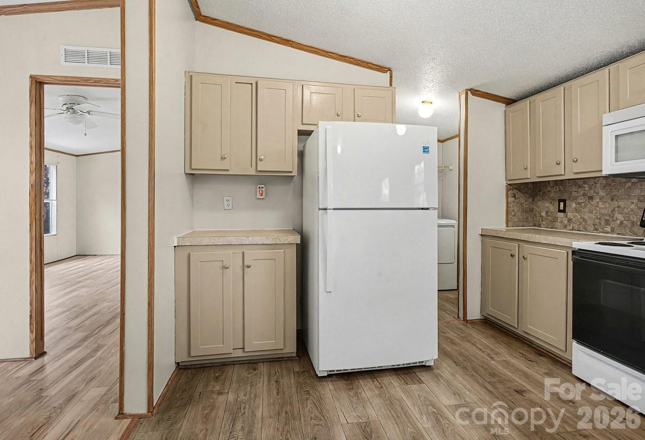 40348 Barnhardt Road New London, NC 28127 - Photo 12 of 38 a white refrigerator freezer sitting in a kitchen
