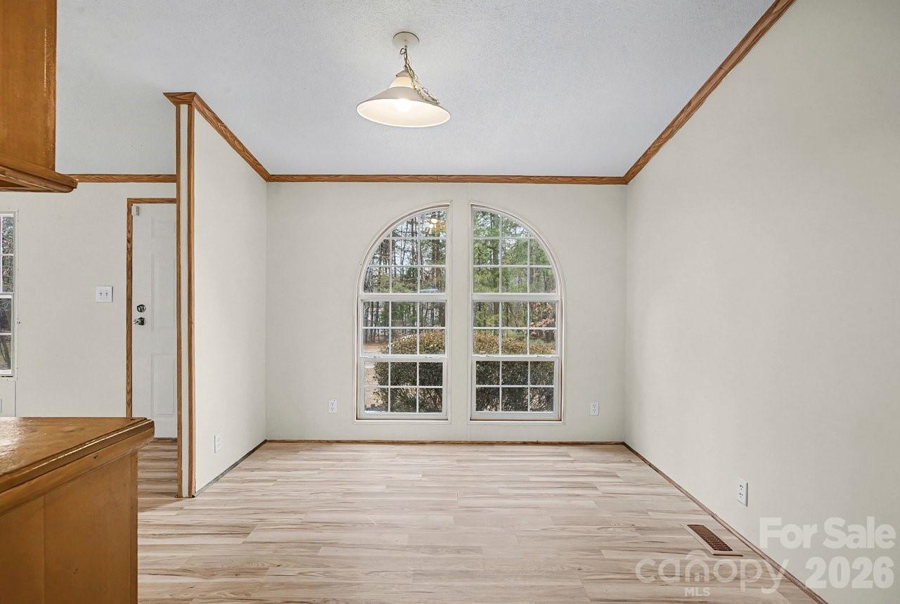 40348 Barnhardt Road New London, NC 28127 - Photo 14 of 38 an empty room with wooden floor and windows