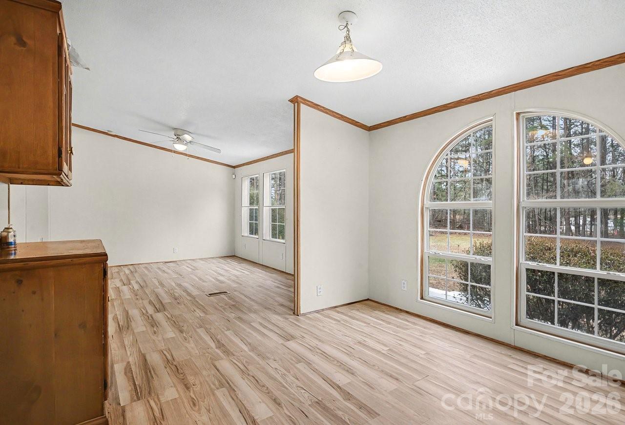 40348 Barnhardt Road New London, NC 28127 - Photo 16 of 38 a view of an empty room with wooden floor and a window