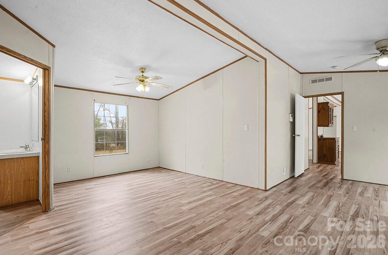 40348 Barnhardt Road New London, NC 28127 - Photo 17 of 38 a view of an empty room with wooden floor and a window