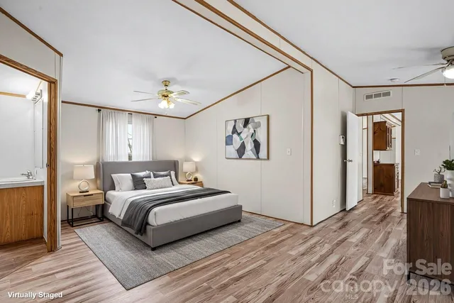 a room with a bed and a ceiling fan