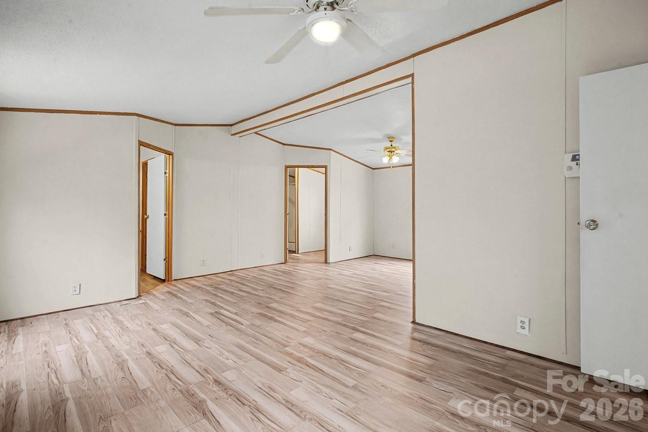 40348 Barnhardt Road New London, NC 28127 - Photo 20 of 38 a view of an empty room with wooden floor and a window