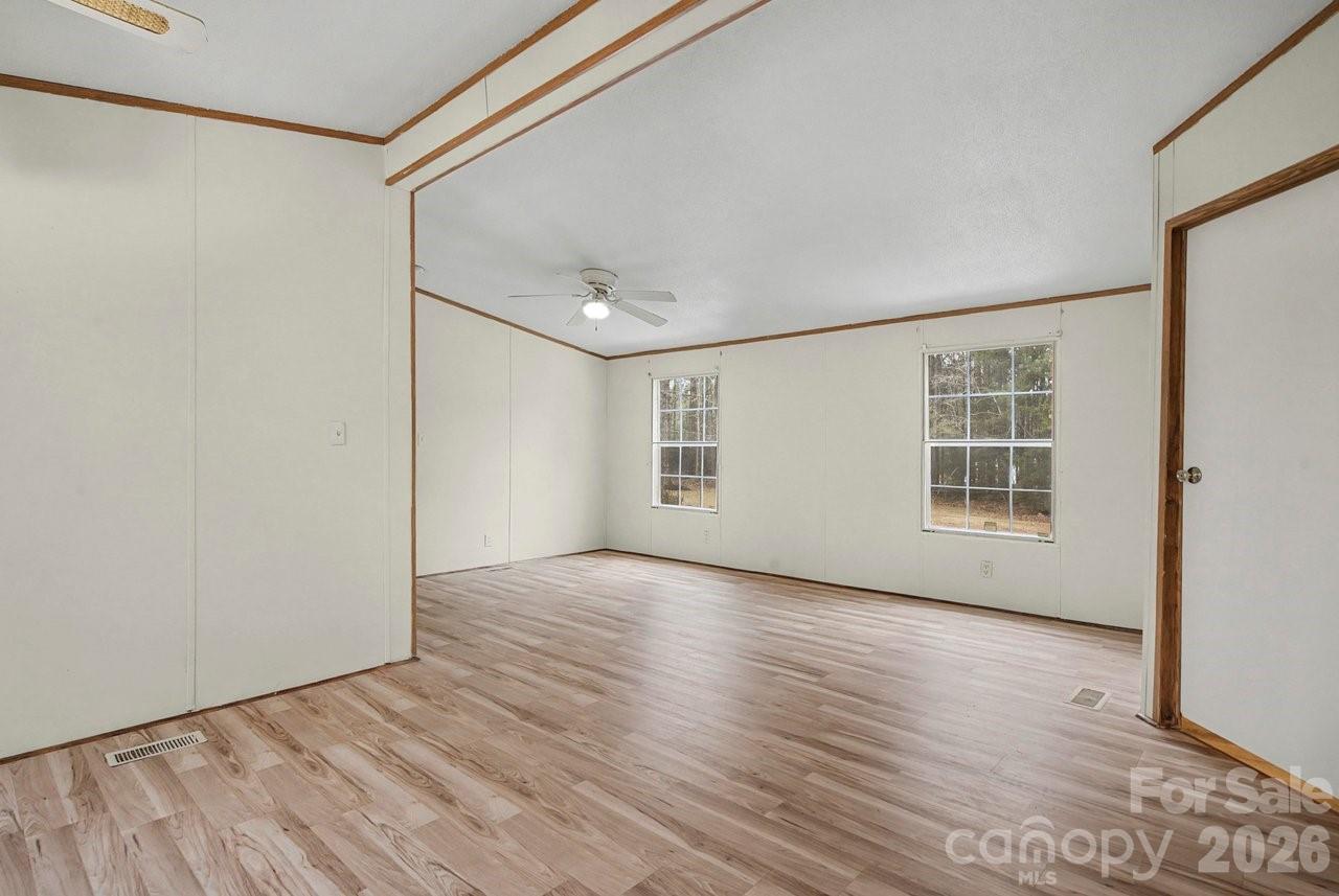 40348 Barnhardt Road New London, NC 28127 - Photo 21 of 38 a view of an empty room with wooden floor and a window