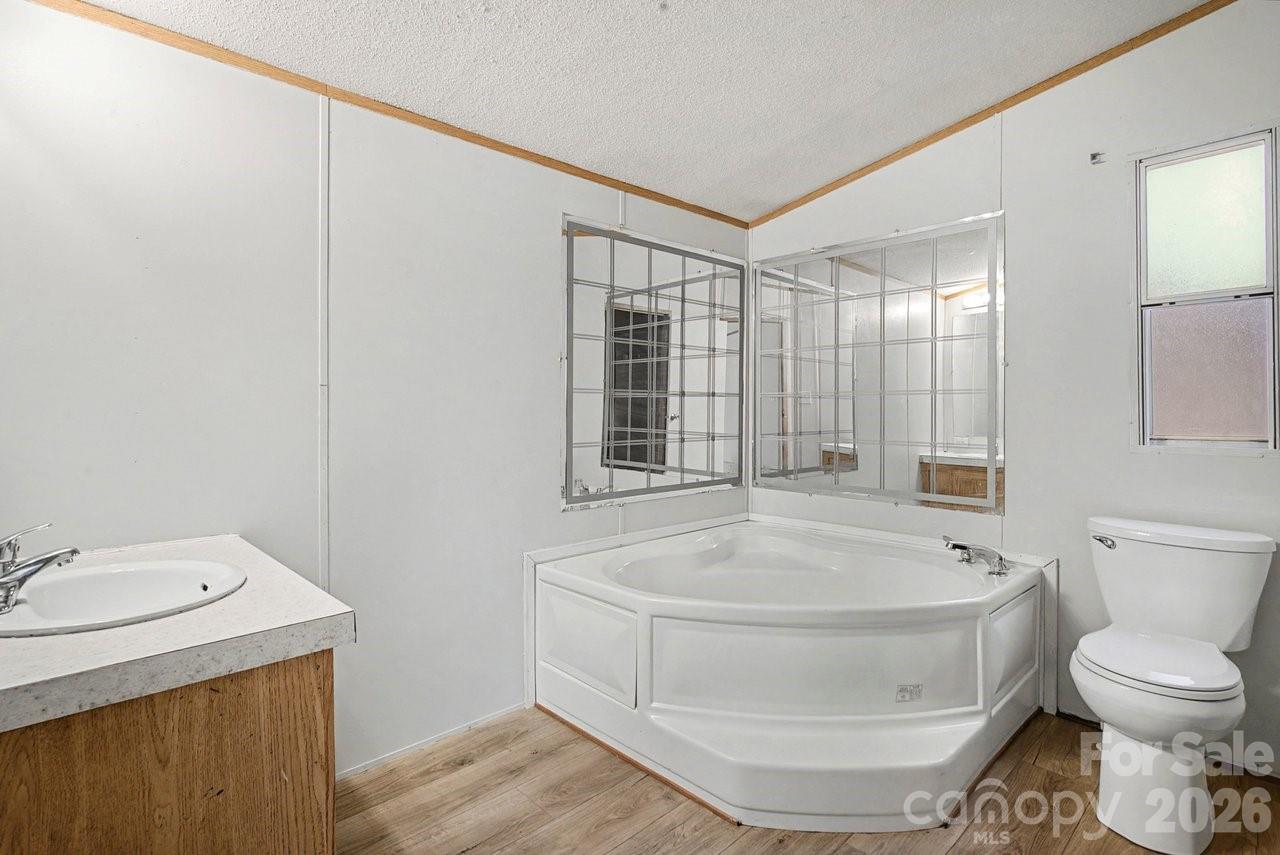 40348 Barnhardt Road New London, NC 28127 - Photo 22 of 38 a bathroom with a sink and a toilet