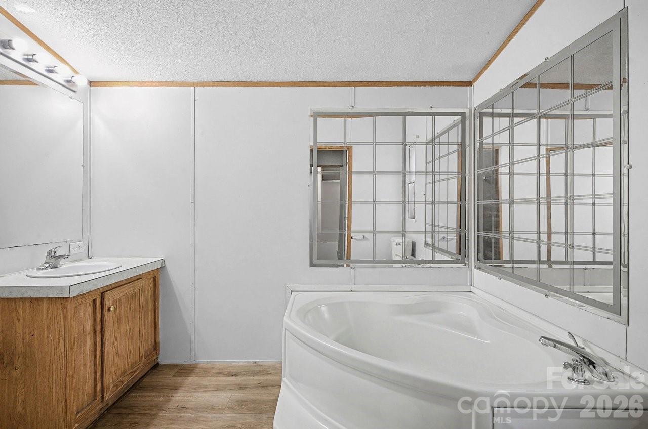 40348 Barnhardt Road New London, NC 28127 - Photo 23 of 38 a bathroom with a bathtub and a sink