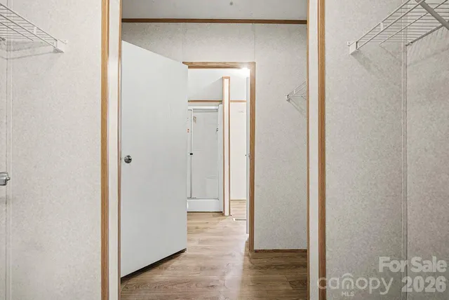 a view of a hallway with wooden floor