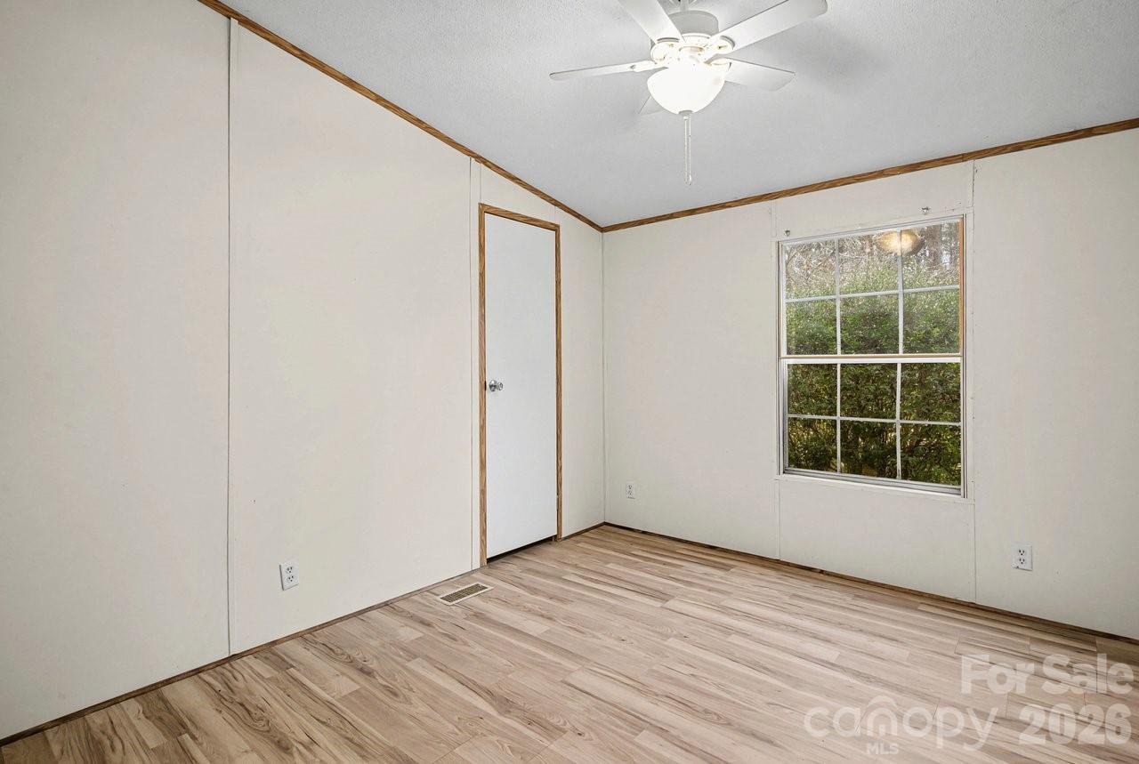 40348 Barnhardt Road New London, NC 28127 - Photo 28 of 38 an empty room with windows and closet