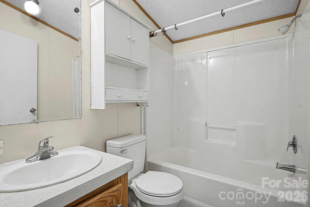 40348 Barnhardt Road New London, NC 28127 - Photo 30 of 38 a bathroom with a sink a toilet and shower