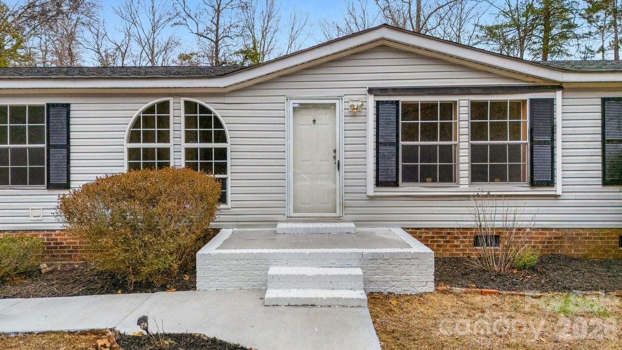 40348 Barnhardt Road New London, NC 28127 - Photo 3 of 38 a front view of a house with garage
