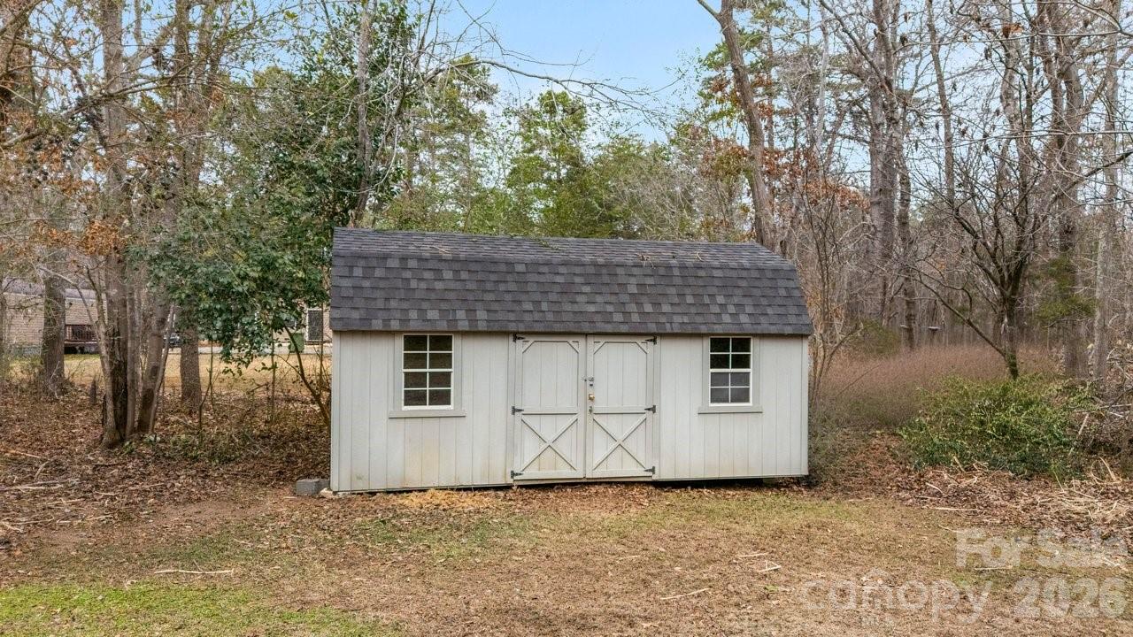40348 Barnhardt Road New London, NC 28127 - Photo 33 of 38 a view of a barn in the middle of a yard