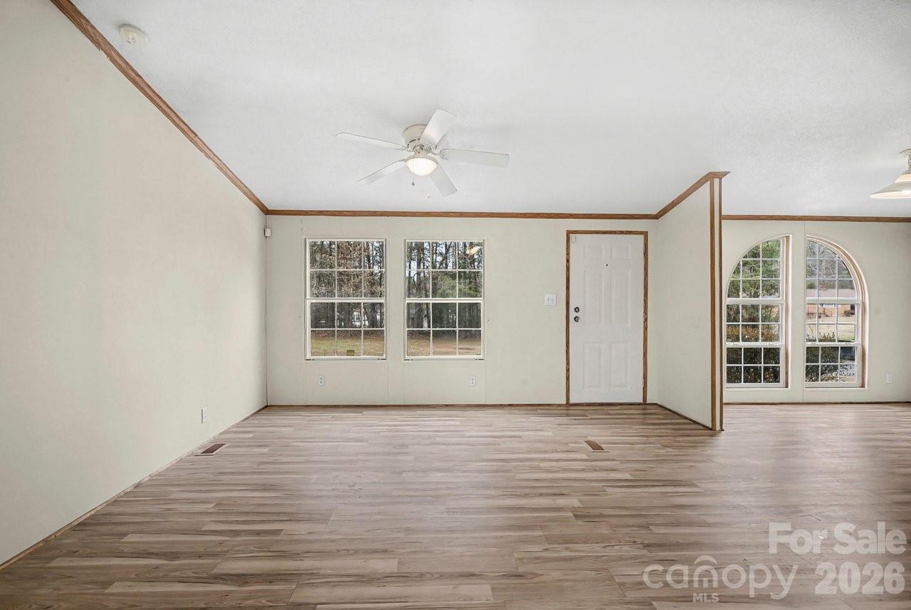 40348 Barnhardt Road New London, NC 28127 - Photo 5 of 38 a view of an empty room with a window and wooden floor