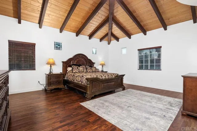 a bedroom with a bed a window and couch