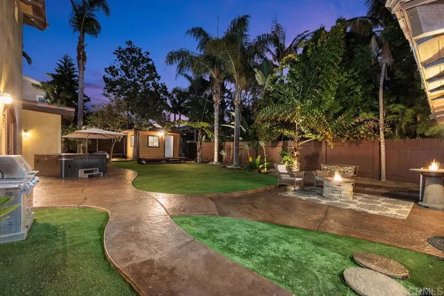 a view of a patio with table and chairs potted plants and a palm tree