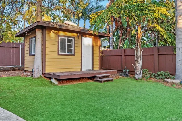 a view of an house with backyard space and garden