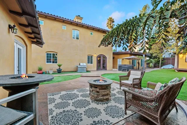 a view of a patio with couches chairs and a fire pit