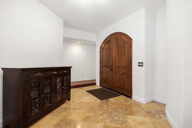 a view of front door with wooden door