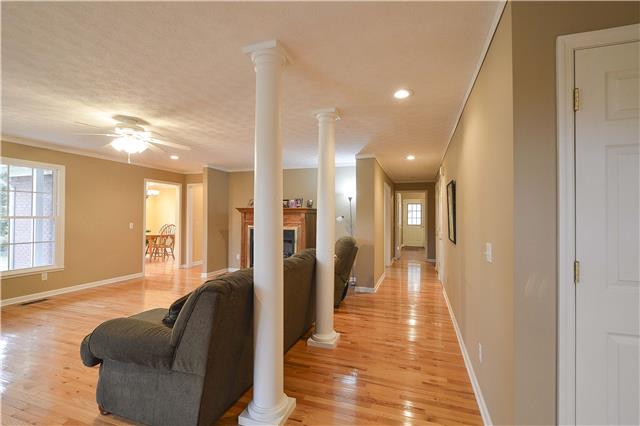 272 Revilo Road Leoma, TN 38468 - Photo 6 of 20 a hallway with couches and a potted plant with wooden floor