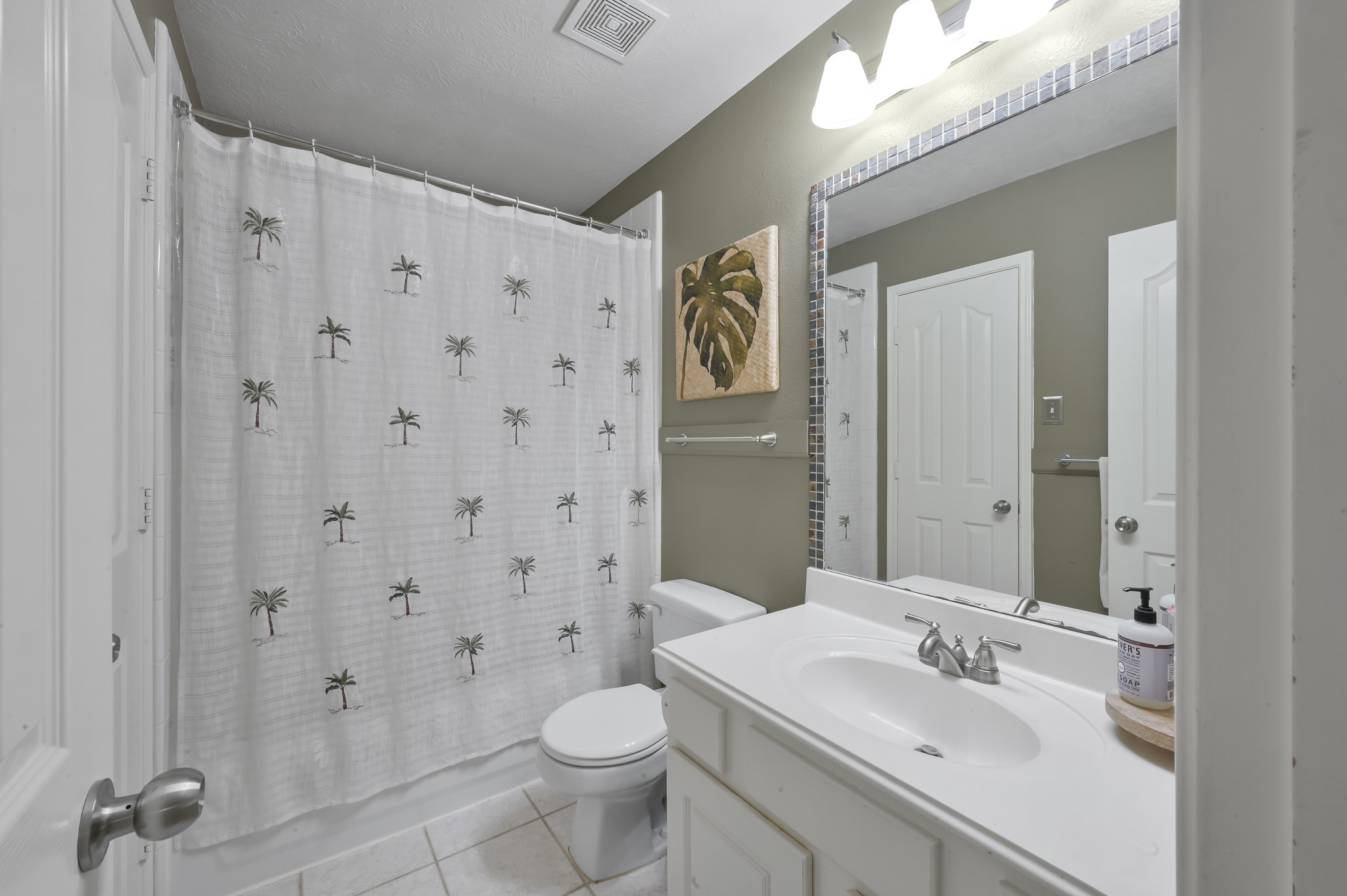 2 Westward Ridge Place The Woodlands, TX 77384 - Photo 35 of 43 Bathroom 3 is on the second floor and features a clean and modern design with white vanity, neutral tone and tile flooring. Access to the full Elfa custom closet located within the bathroom