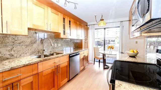 a kitchen with granite countertop sink and cabinets