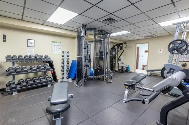 a room with gym equipment and large mirror