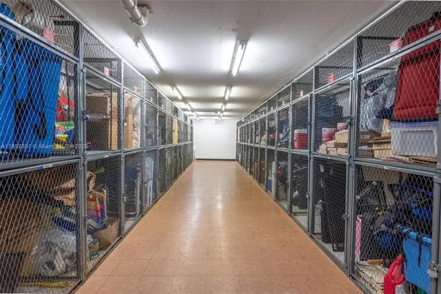 a view of swimming pool with lawn chairs and plants