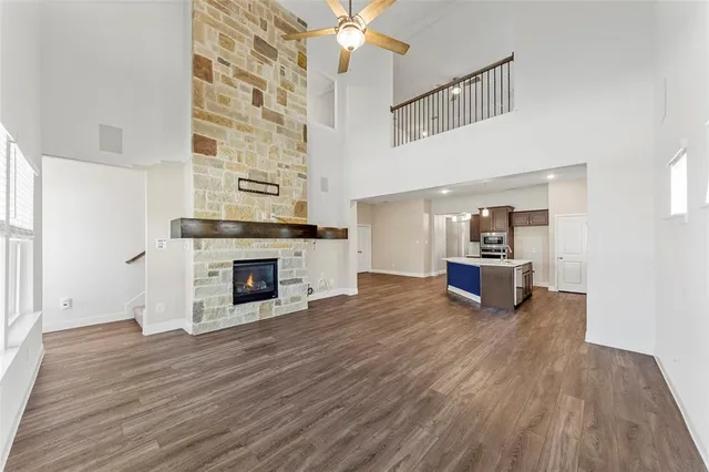a view of a livingroom with a fireplace and wooden floor