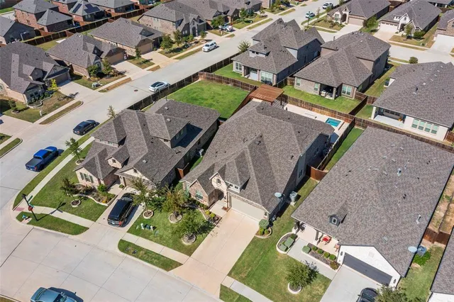 an aerial view of residential houses with outdoor space