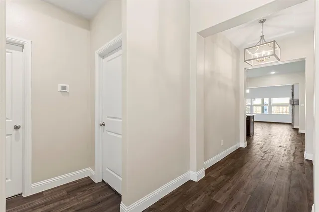 a view of a hallway with wooden floor and closet area