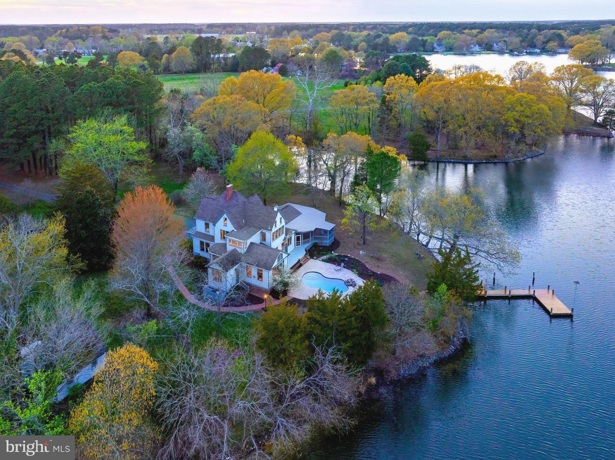 an aerial view of lake residential house with swimming pool and outdoor space