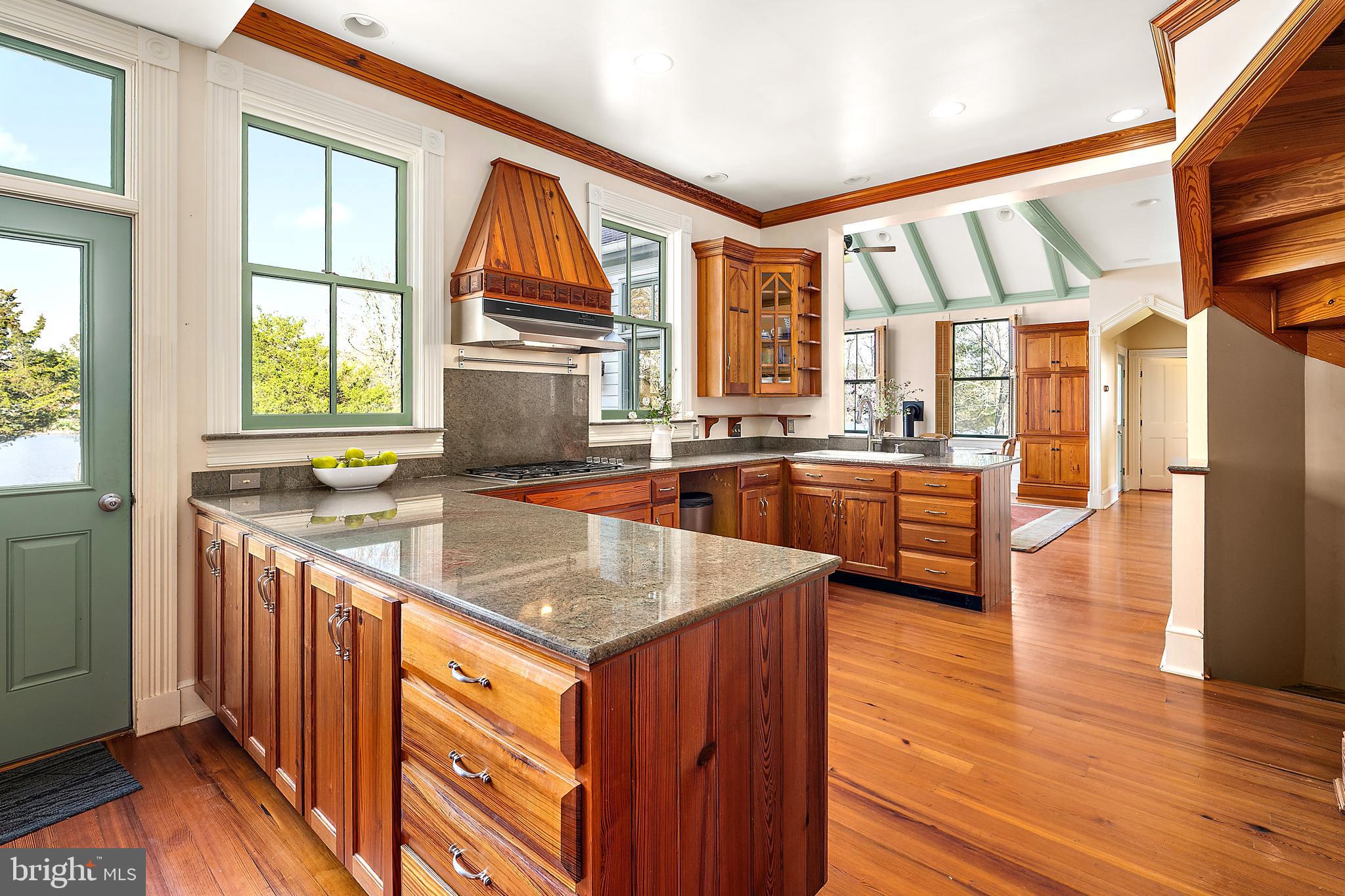 26090 Royal Oak Road Easton, MD 21601 - Photo 24 of 74 a kitchen with stainless steel appliances granite countertop a stove and a kitchen island