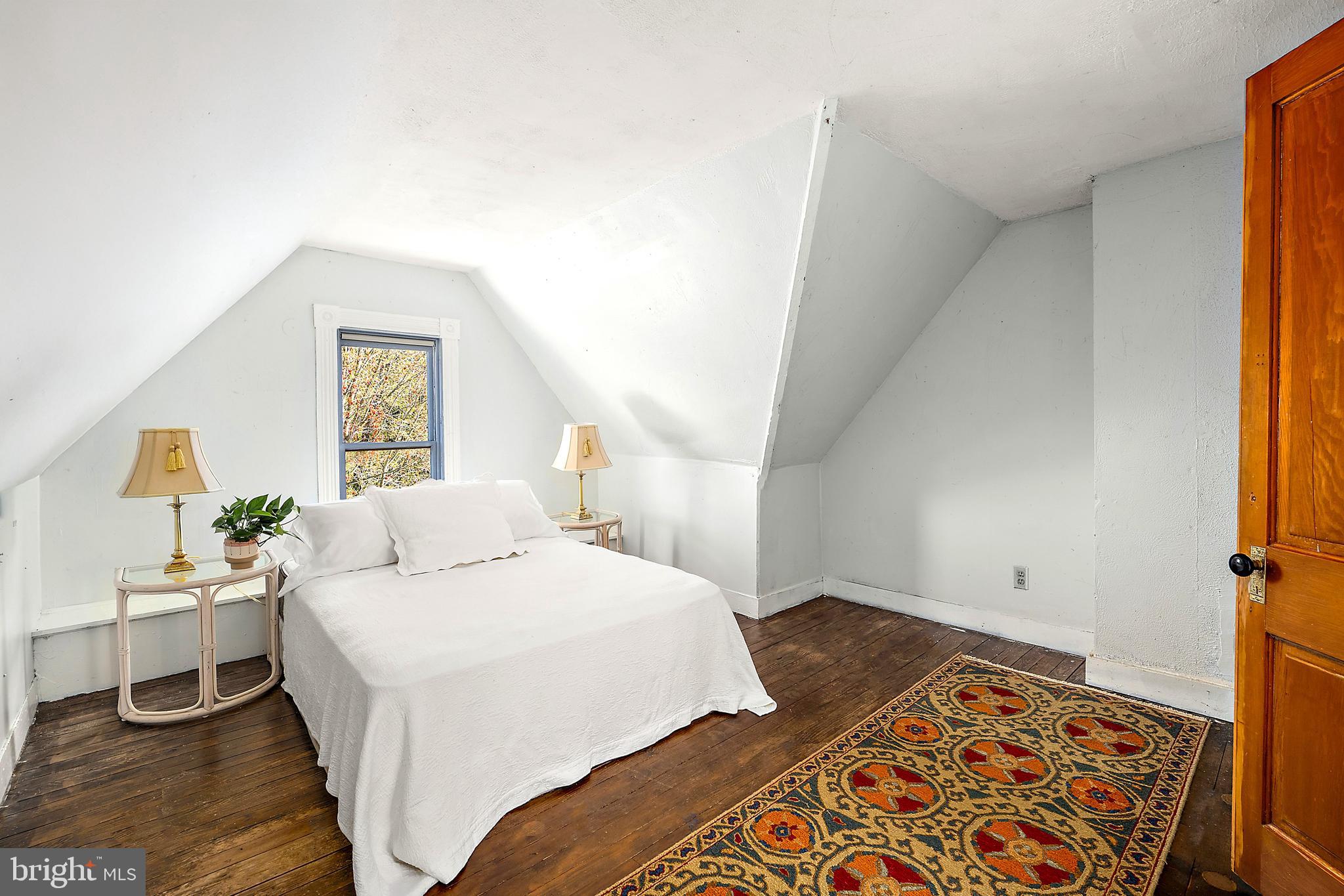 26090 Royal Oak Road Easton, MD 21601 - Photo 46 of 74 a bedroom with a bed and wooden floor