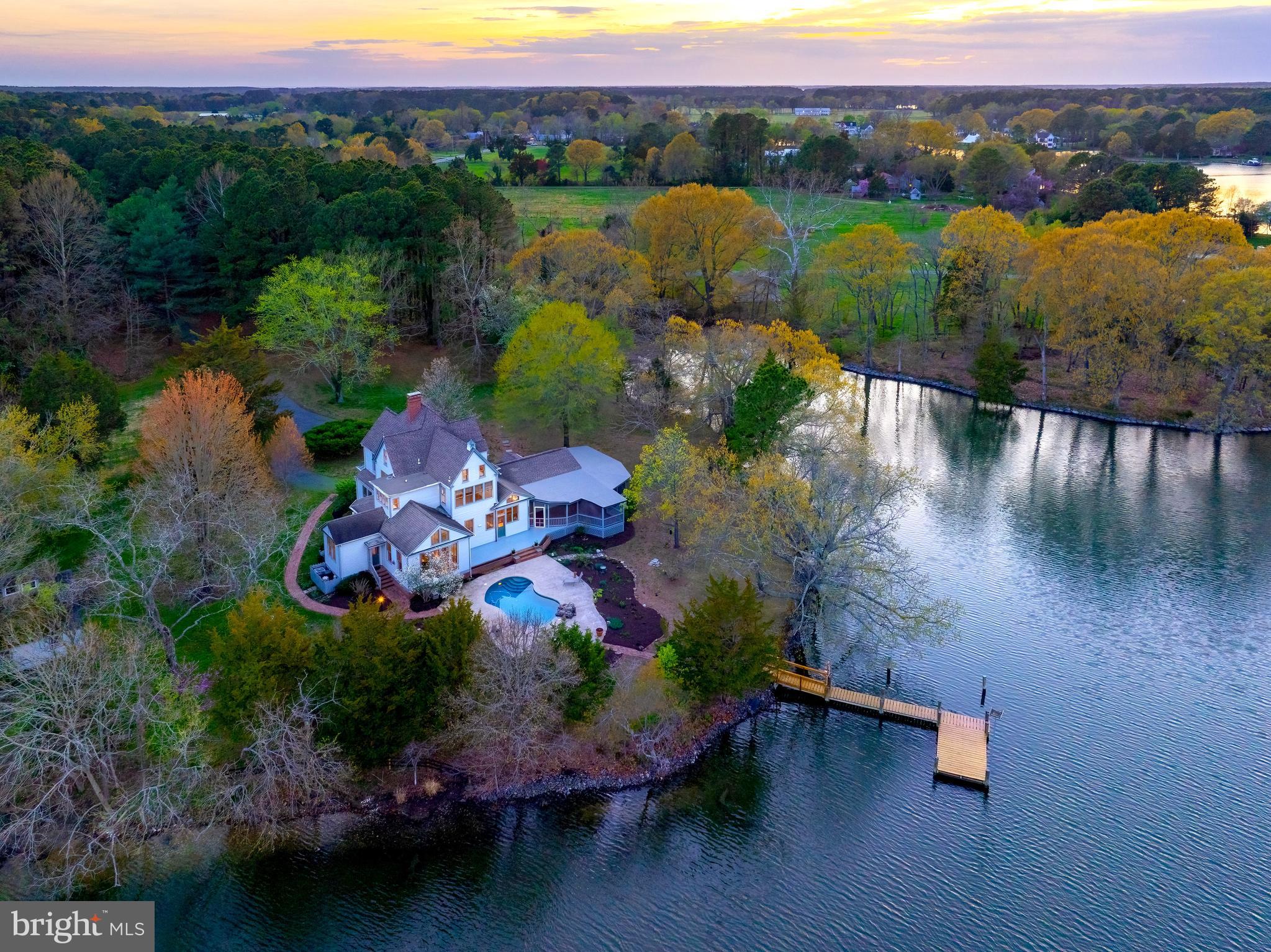 26090 Royal Oak Road Easton, MD 21601 - Photo 5 of 74 an aerial view of a house with a garden and lake view