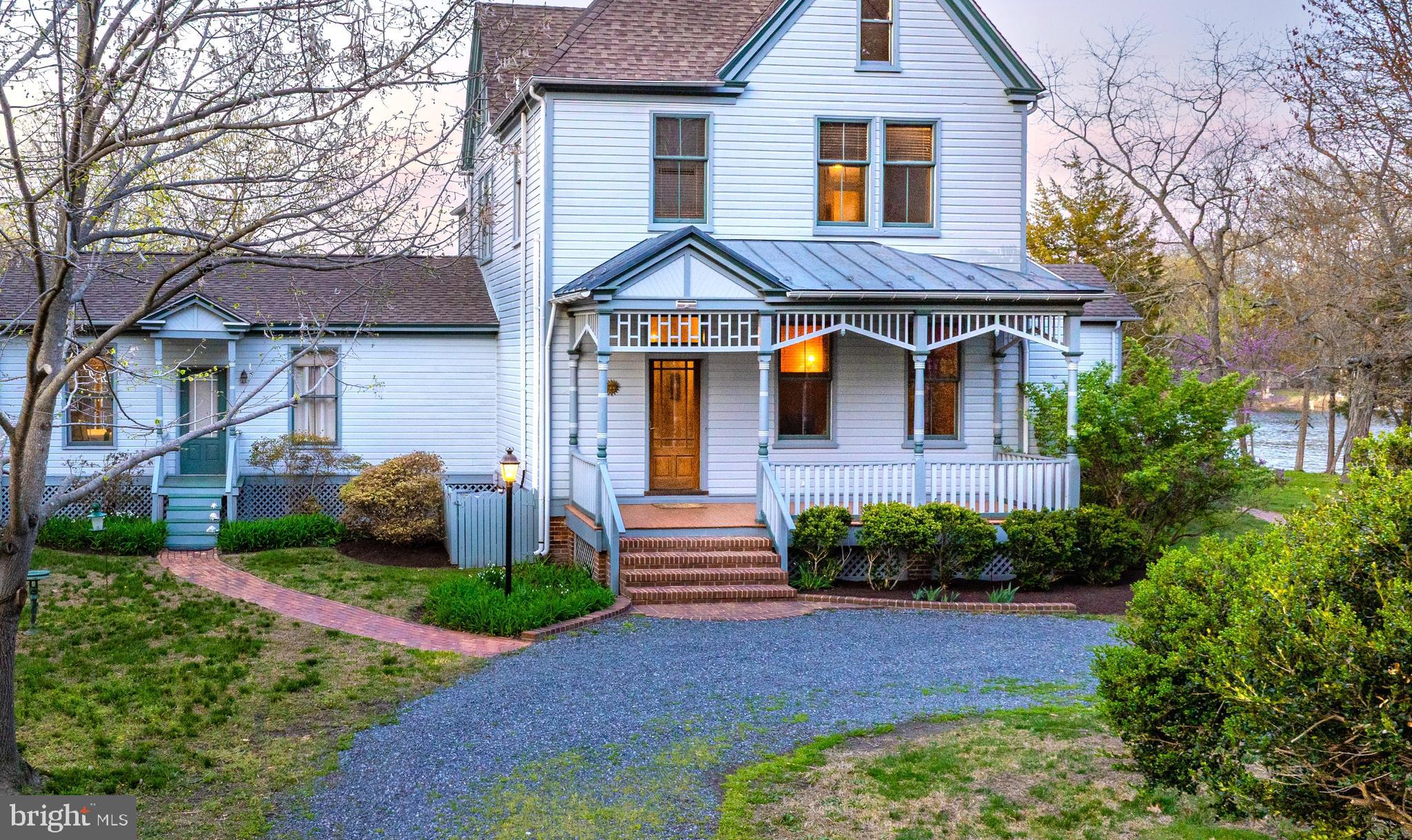 26090 Royal Oak Road Easton, MD 21601 - Photo 9 of 74 a front view of a house with a yard and potted plants