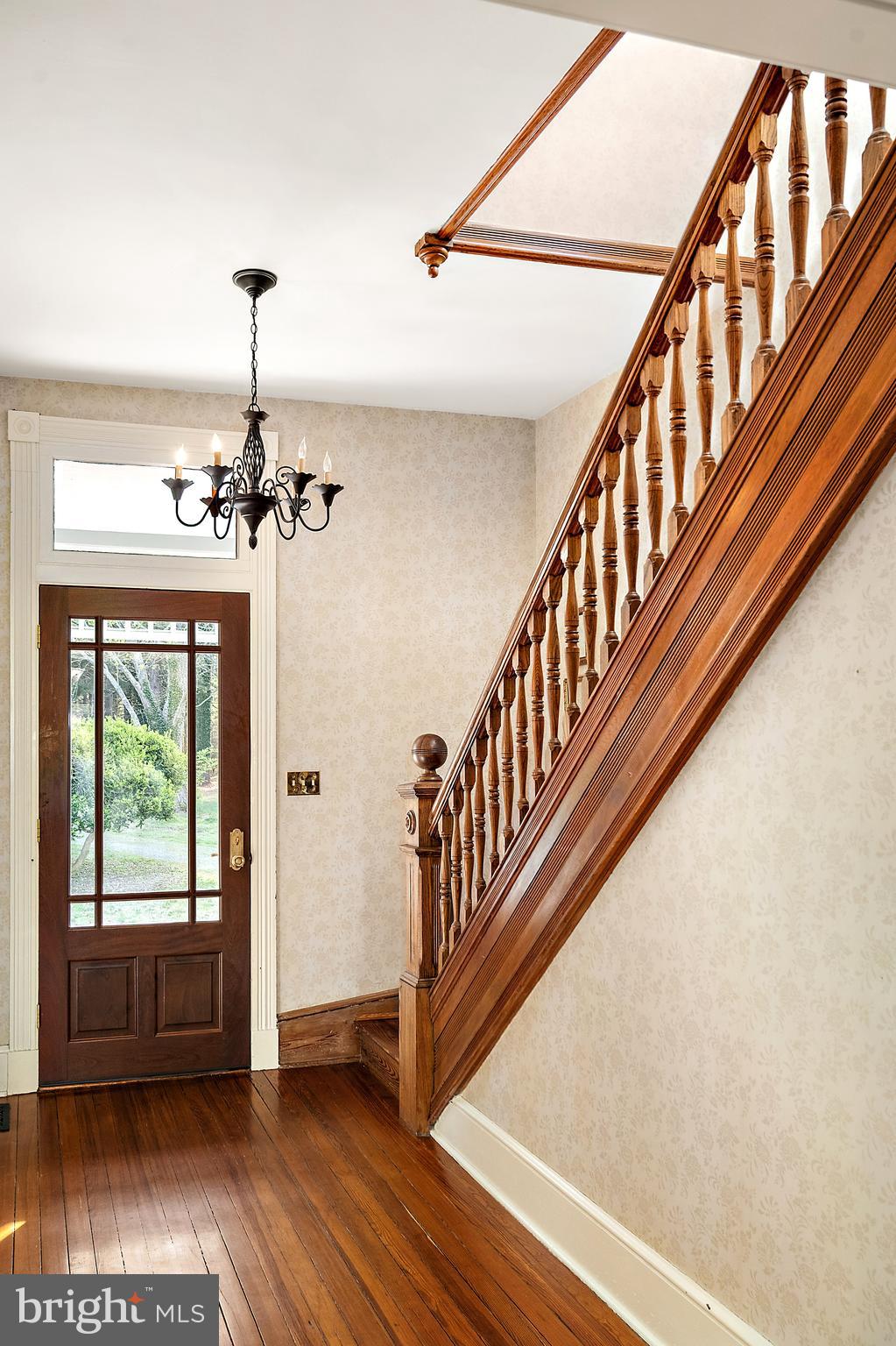 26090 Royal Oak Road Easton, MD 21601 - Photo 10 of 74 a view of an entryway wooden floor and staircase