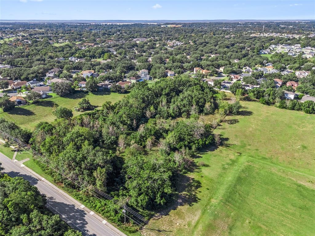 2228 Vick Road Apopka, FL 32712 - Photo 15 of 26 an aerial view of residential houses with outdoor space and trees