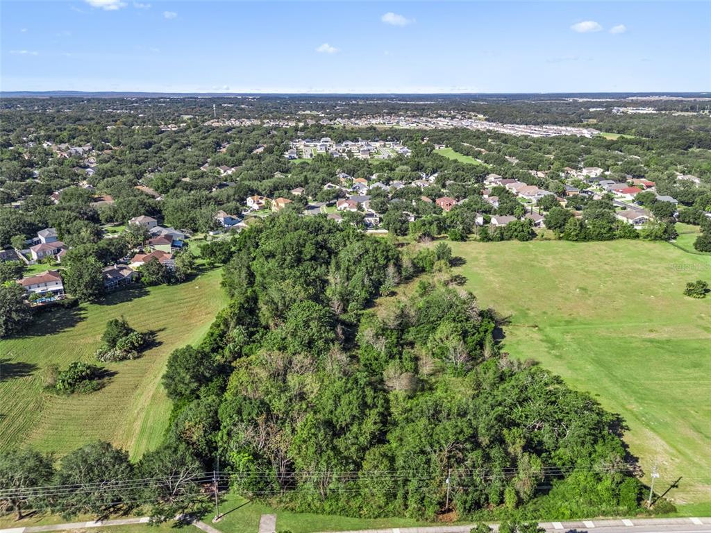 2228 Vick Road Apopka, FL 32712 - Photo 18 of 26 an aerial view of residential houses with outdoor space and trees