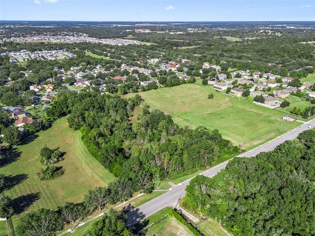 2228 Vick Road Apopka, FL 32712 - Photo 20 of 26 an aerial view of residential houses with outdoor space and trees